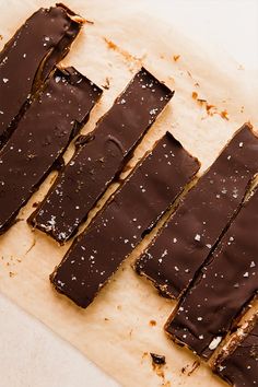 pieces of chocolate sitting on top of a piece of parchment paper