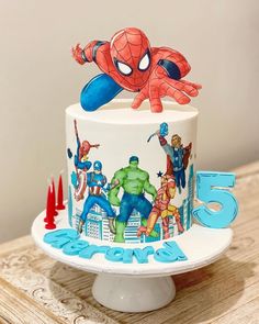 the birthday cake is decorated with an image of spider - man and other superheros