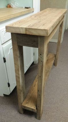 a wooden table sitting in the middle of a kitchen