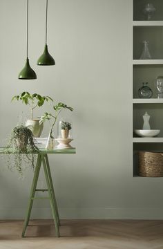 some plants are sitting on a small table