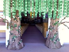 a church decorated with green ribbon and tree trunks for the front entrance to the room