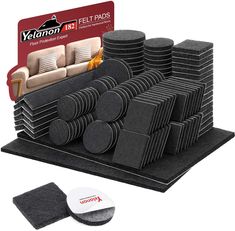 a pile of black felt pads sitting on top of a table next to a coaster