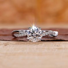 a diamond ring on top of a piece of wood