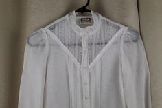 "Rare Childs/Girls white blouse Gunne Sax Jessica's Gunnies Blouse has double layer but single layer on sleeve Lace trim on sleeves and sheer lace insert on blouse with classic Gunne Sax satin ribbon detail We are not great on childs sizes so please use measurements below. We think this is a size 10 Girlss/child Pearl buttons Good condition Missing one button on one cuff See photo #7. Has been sewn closed. Very light fading Hand washed and ready to wear! Measurements Underarm to underarm: 15.5\" Heirloom Dresses, Gunne Sax, Girls Blouse, Lace Insert, Pearl Buttons, White Blouse, Sheer Lace, Lace Trim, Sleeveless Top