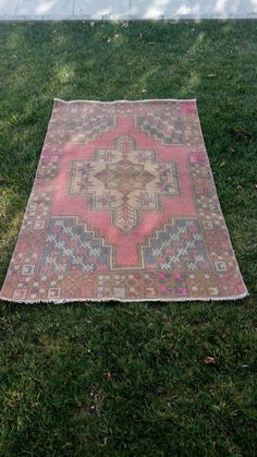 an old rug is laying in the grass