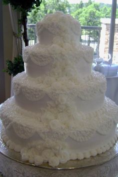 a large white wedding cake sitting on top of a table