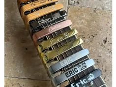 an assortment of guitar picks sitting on top of each other in front of a tile floor