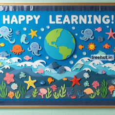 a bulletin board that says happy learning with sea animals and fish around the world on it