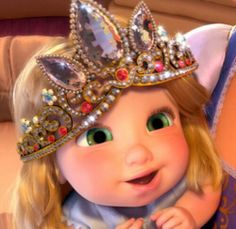 a close up of a child wearing a tiara and holding her hand on her chest