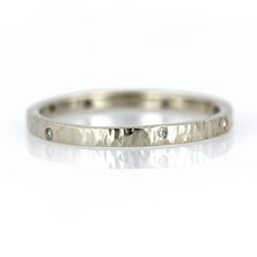 This is a beautiful organic hammered diamond handcrafted ring band with a hammer texture and high shine finish. It is crafted with 7 conflict-free diamonds placed organically around the ring band. Details • 7 Diamonds measuring 1mm - 1.3mm - VS clarity /G+• Band measurements: 2mm wide x 1.5mm thick• Hammer texture with a high shine polished finish Handcrafted Rings, Diamond Rings Bands, Conflict Free Diamonds, Promise Rings, Band Rings, Diamond Ring, Wedding Bands, Yellow Gold, Rose Gold