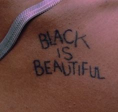 the back of a woman's stomach with writing on it that says, black is beautiful