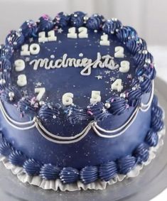 a blue cake with white frosting and numbers on it