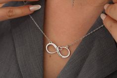 Embrace the timeless bond between mother and child with our Personalized Minimalist Infinity Necklaces. Crafted from durable stainless steel and featuring a waterproof design, these necklaces are a symbol of everlasting love and connection. The minimalist infinity pendant can be personalized with custom engraving, such as names, initials, or a meaningful date, adding a unique touch to this elegant piece of jewelry. Whether it's a Mother's Day gift, a birthday present, or a token of appreciation, Infinity Stainless Steel Necklace For Anniversary, Minimalist Stainless Steel Jewelry For Mother's Day, Adjustable Stainless Steel Necklace For Mother's Day, Mother's Day Metal Jewelry Gift For Mom, Hypoallergenic Stainless Steel Necklace For Anniversary, Infinity Metal Necklace For Gifts, Infinity Metal Necklace For Gift, Infinity Metal Jewelry For Wedding, Elegant Customizable Metal Necklaces