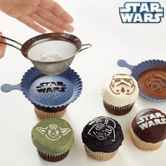 star wars themed cupcakes are being held by someone's hand with a strainer