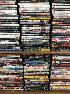 many dvds are stacked on top of each other