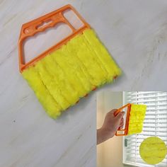 a hand holding a sponge and a yellow mop on top of a white counter