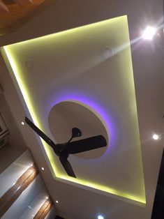 a clock mounted to the side of a ceiling in a room with lights on it