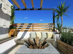 an outdoor seating area on the roof of a building