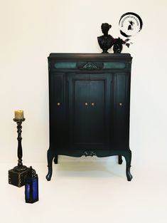 a black cabinet next to a candle holder