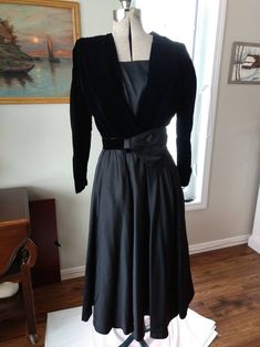 Stunning Vintage Black Velvet and Satin Formal Dress Long Sleeves Full Skirt Pleated Fan Belt Side Zipper Handmade This special occasion dress is in good used vintage condition and has a little wear from use and age. Measurements are approximately: Bust: 37" Waist: 27" Hips: 31" Length of skirt: 31.75" It is in good used vintage condition with some minimal wear due to use and age. Black Dress Velvet, Formal Black Dress, Vintage Cardigan Sweater, Satin Formal Dress, Dress Velvet, Long Sleeve Dress Formal, Black Dress Formal, Dress Handmade, Black Velvet Dress