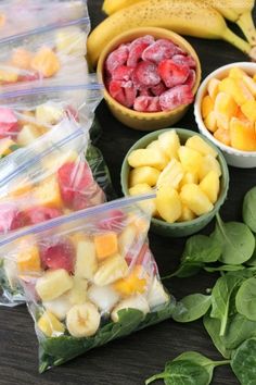 fruits and vegetables are in plastic bags on a table