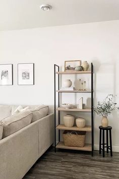 a living room filled with furniture and decor on top of a hard wood floored floor