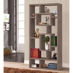 a bookshelf with several different types of books on it in a living room