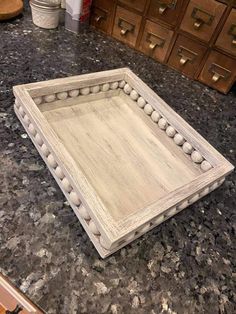 a wooden tray sitting on top of a counter