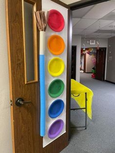 an office hallway decorated with colorful plates and brooms