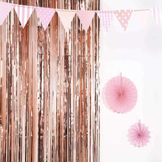 pink and gold party decorations with paper fans