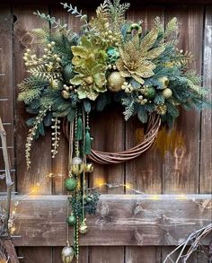 a wreath is hanging on the side of a wooden fence