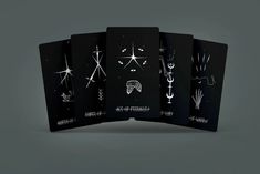 four black cards with white designs on them