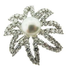 This stunning platinum floral brooch exemplifies classic jewelry, with petals which are set with 80 fine round brilliant-cut diamonds, weighing 5.22 carats and centered by an exquisite 10.5mm white pearl. Diamond Ribbon, Diamond Tops, Diamond Bows, Pearl Pin, Floral Brooch, Diamond Eyes, Diamond Brooch, Classic Jewelry, Antique Diamond