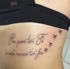 a woman's lower back tattoo with birds and the words, pr quenten fo na nuece ten form