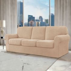 a living room scene with focus on the couch and cityscape in the background