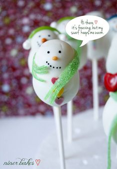 some cake pops with frosting on them are decorated like snowmen