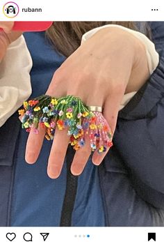 a person wearing a ring made out of beads