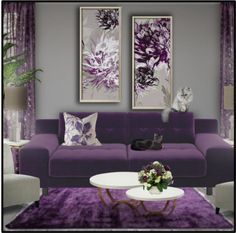 a living room filled with purple furniture and paintings on the wall above it's coffee table