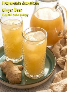 homemade jamaican ginger beer on a plate with fresh ginger root in the glass next to it