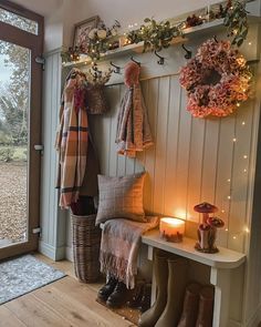 the entryway is decorated with wreaths, lights, and boot boots for winter