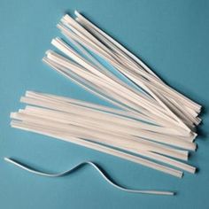 several white plastic straws on a blue surface