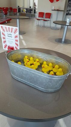 some yellow rubber ducks in a metal tub