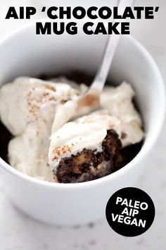 a white bowl filled with cake and whipped cream