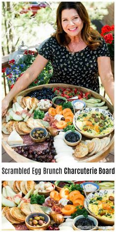 a woman standing in front of a large platter filled with different types of food