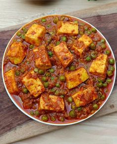 tofu and peas in tomato sauce on a plate