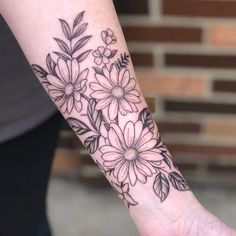 a woman's arm with flowers on it