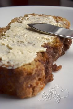 a piece of bread with cream cheese on top and a spoon sticking out of it