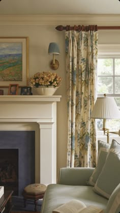 a living room filled with furniture and a fire place in front of a painting on the wall