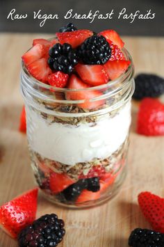 a glass jar filled with yogurt and berries