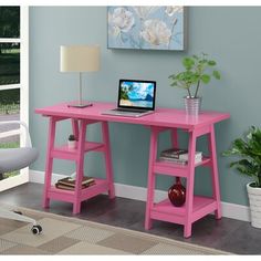 a pink desk with a laptop on it